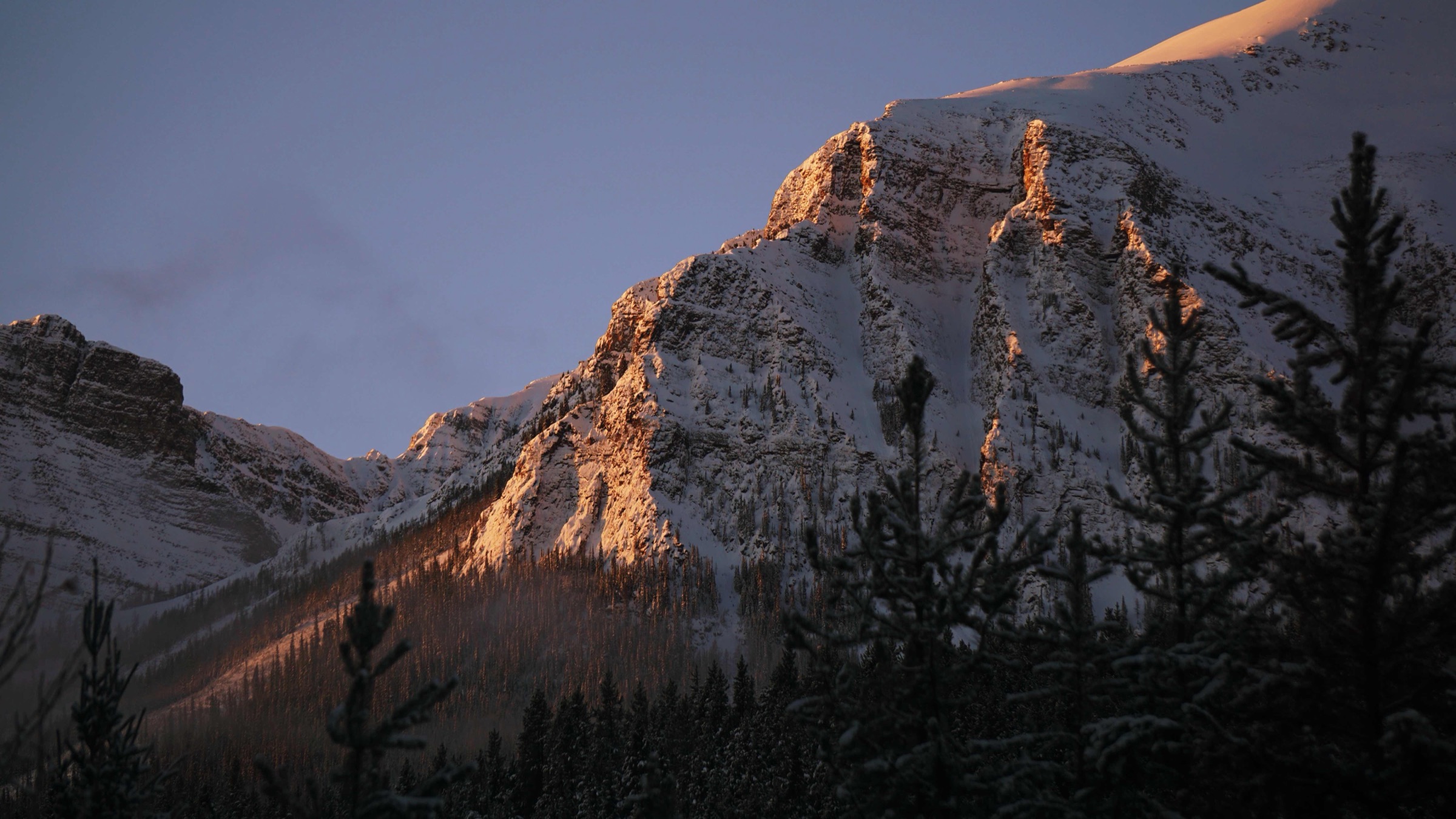 Warm evening light on a snow-covered alpine ridge