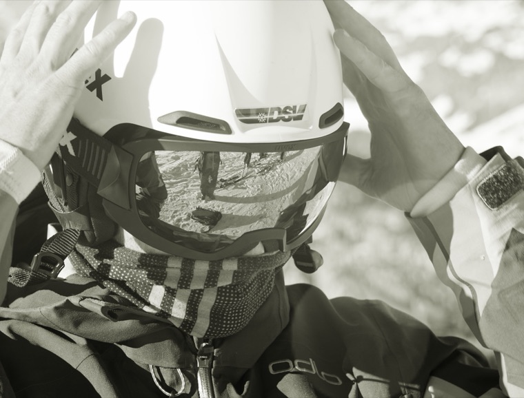 Pulling on the helmet before the start, black and white