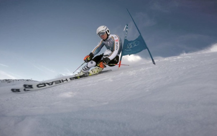 Giant slalom training turn under a grey sky