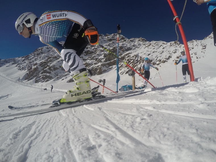 Low on the skis in a turn, close-up from the side