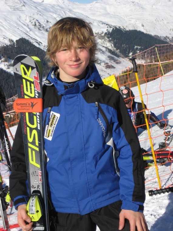 Young racer with his skis